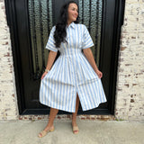 Adorable Blue and White striped button up midi dress with cinched waist and beige sandals 