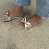 Solei Sea Rafie Metallic Gold Bow Sandals in Gold