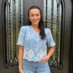 Light blue denim embroidered blouse.
