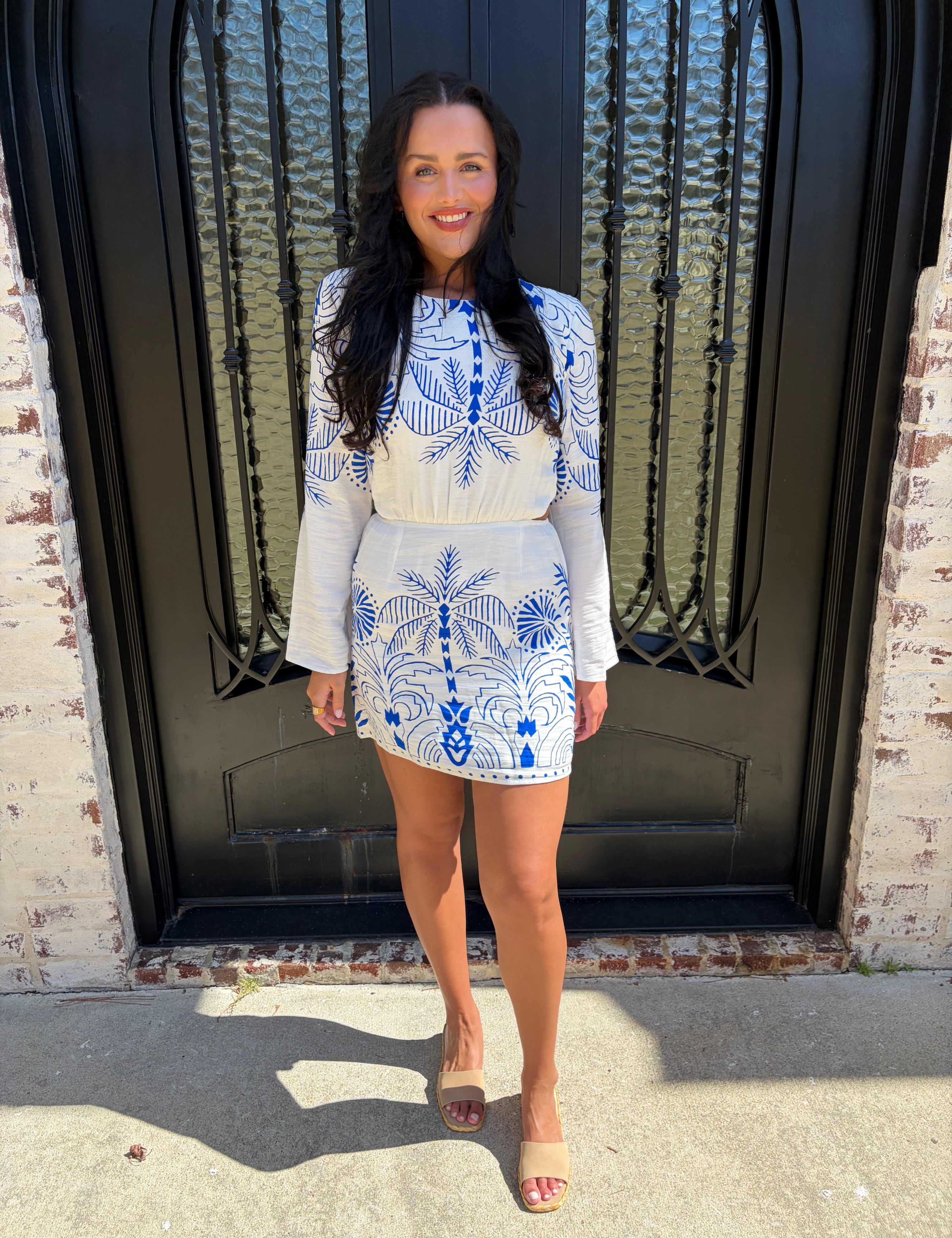 Blue and White Nautical Palm Mini dress with side cutouts paired with beige sandals 