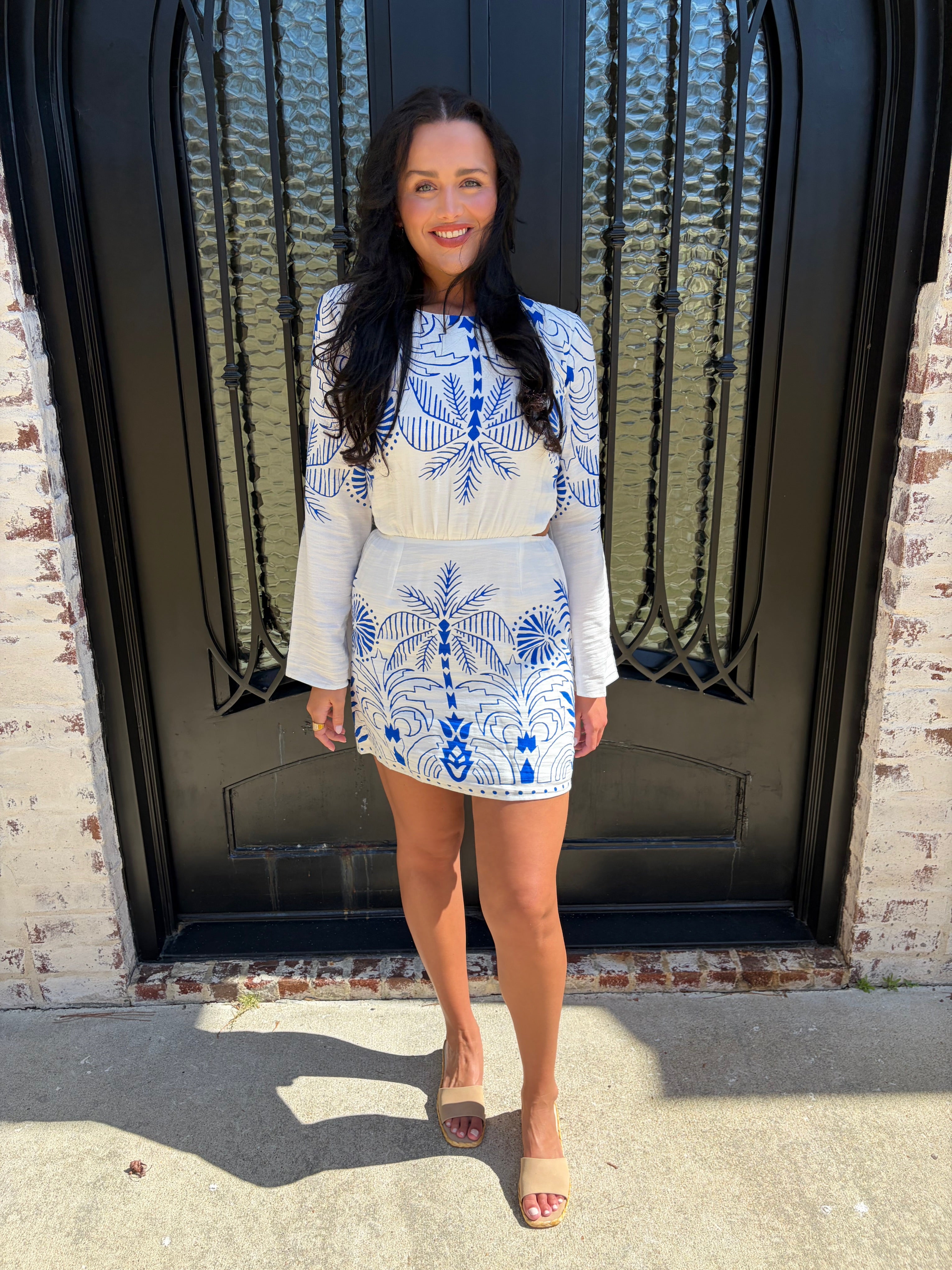 Blue and White Nautical Palm Mini dress with side cutouts paired with beige sandals 